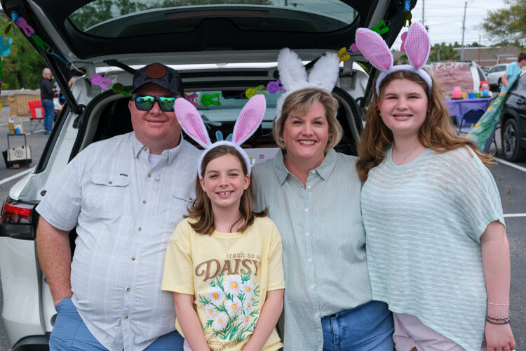 A family in bunny ears at the Easter Celebration
