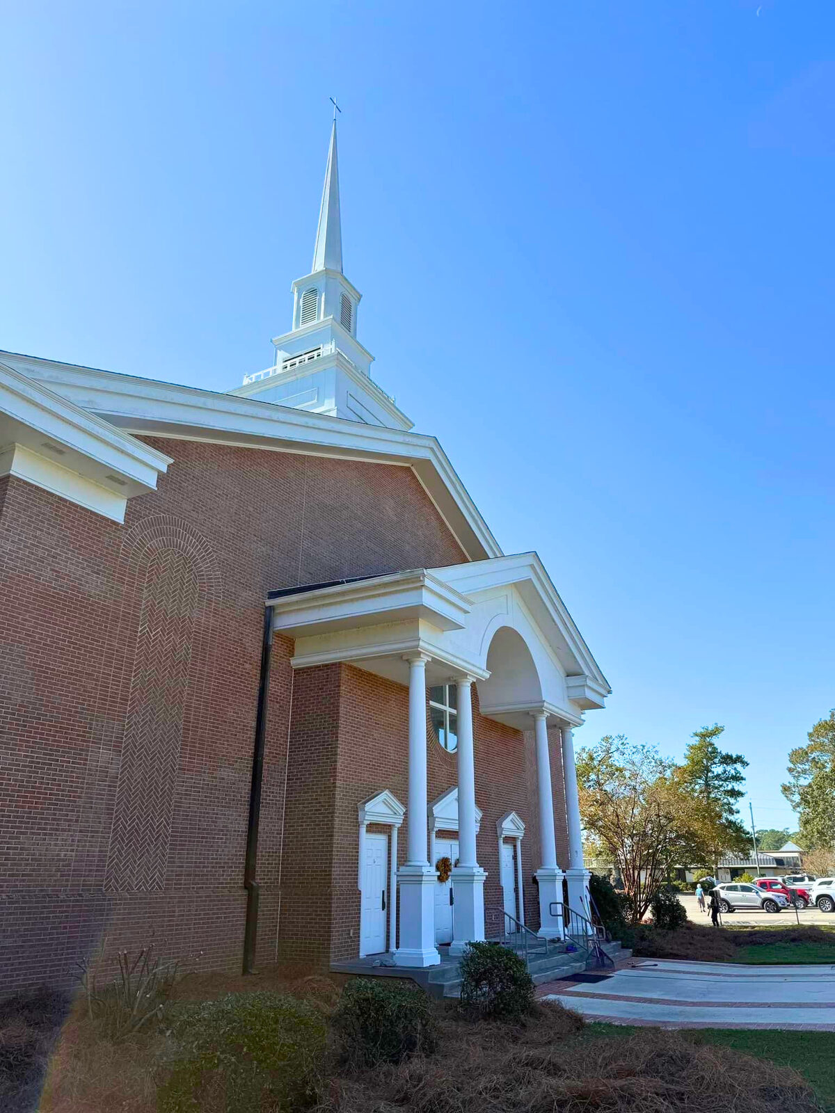 The steeple of Spanish Fort UMC against a blue sky