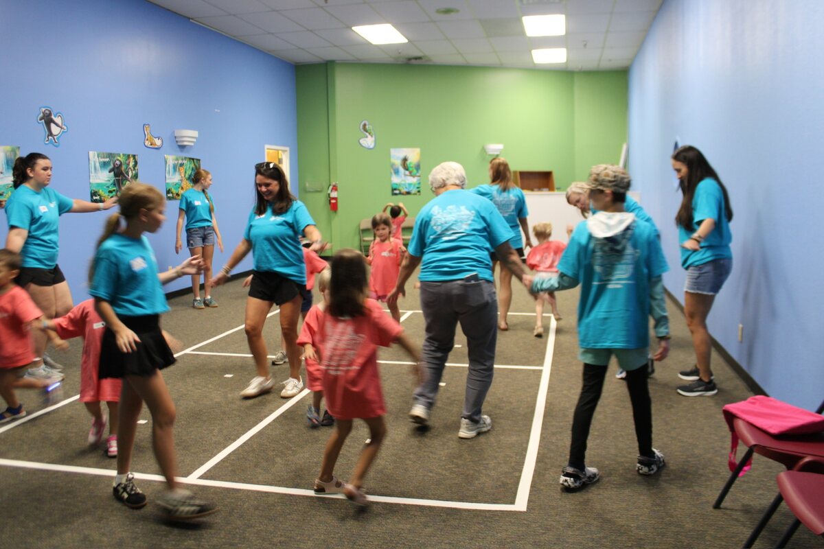 Vacation Bible School volunteers at the photo wall
