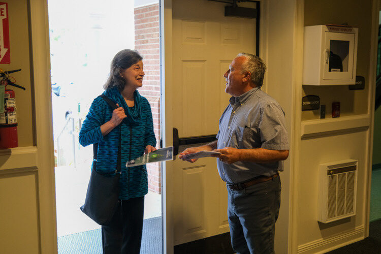 A staff member welcoming a guest at the door